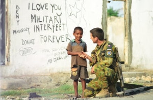 An Australian soldier with young East Timorese boy. Photo by Department of Defence